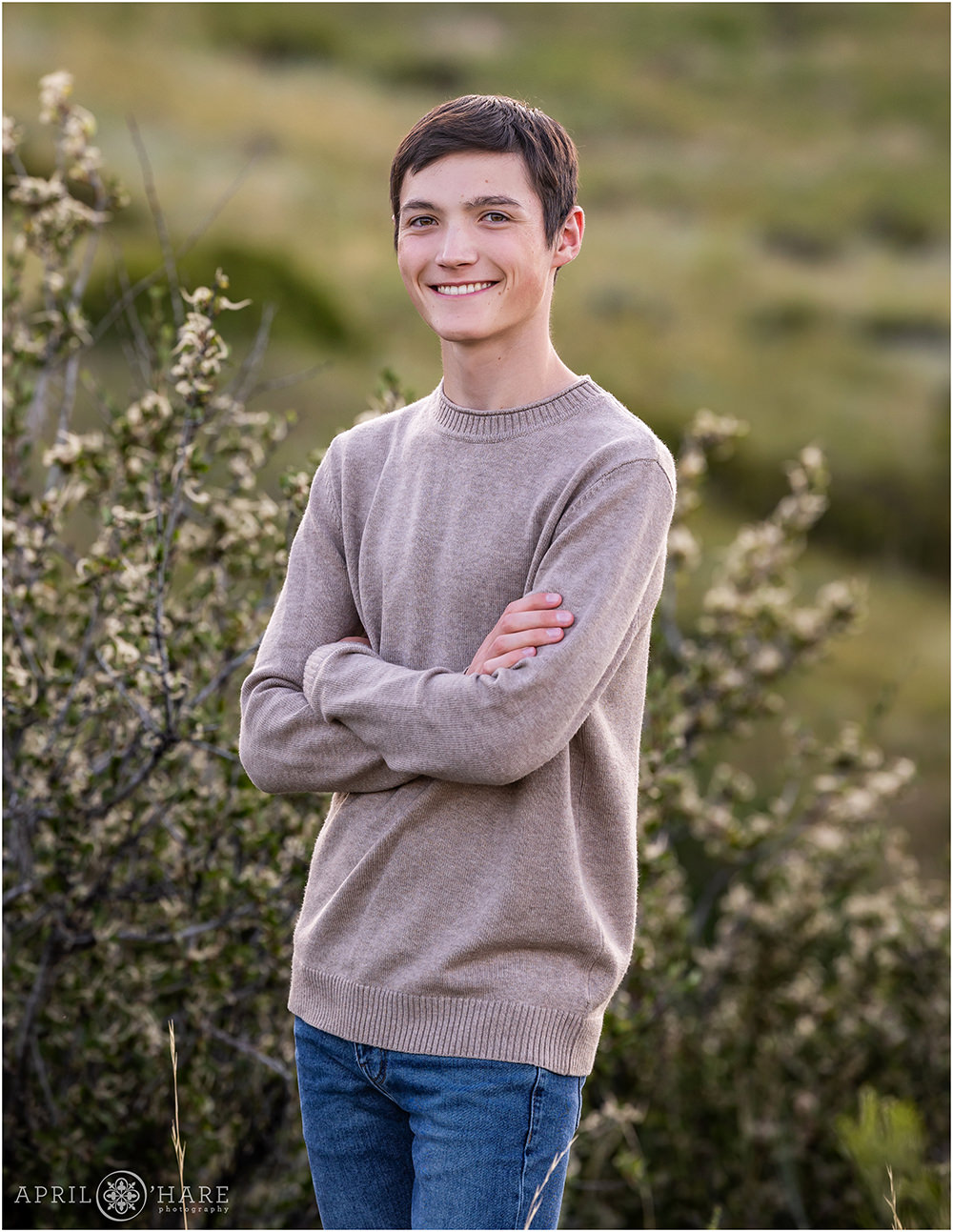 Classic senior photo with a nice green backdrop at Morrison Trailhead during summer in Colorado
