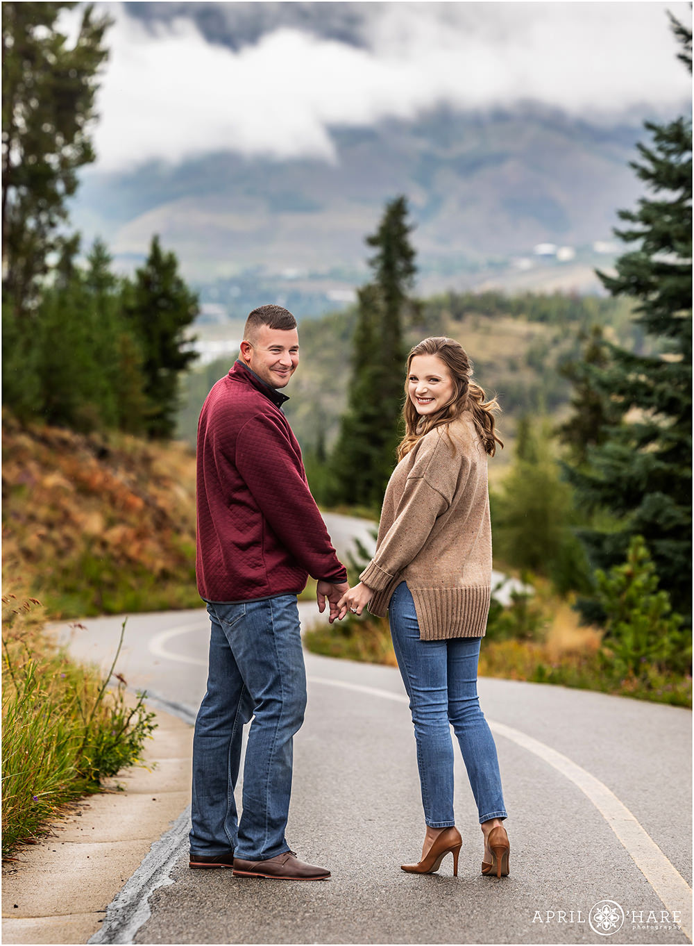 Cute couple walk on a path at Sapphire Point on a misty summer evening in Colorado