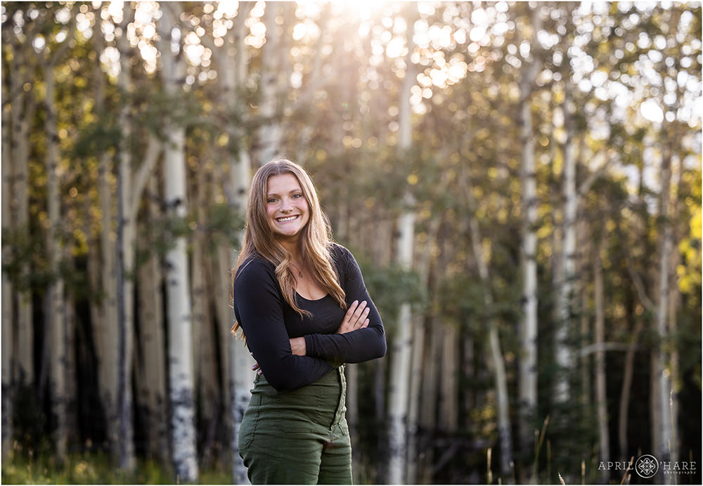 High school senior photo in front of an aspen tree meadow in Evergreen Colorado