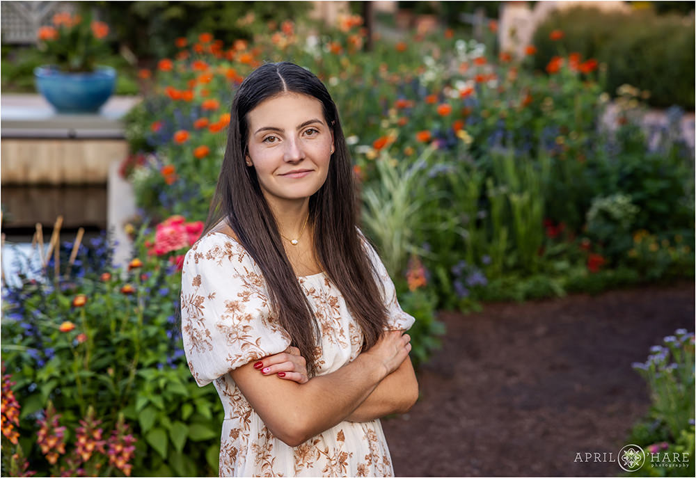 Gorgeous garden senior photos with bright colorful flower backdrop at Denver Botanic Gardens