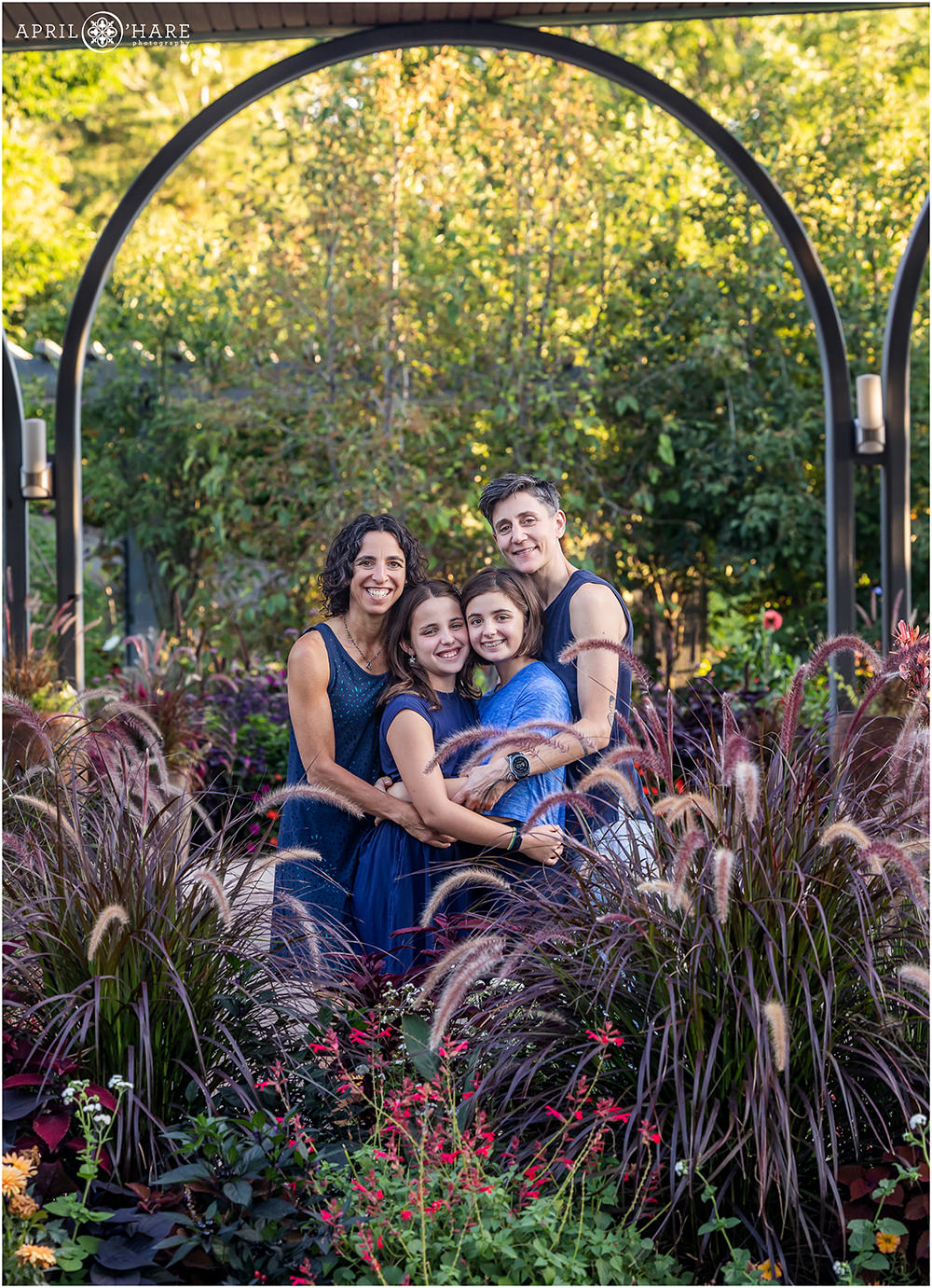 Cute family with two daughters under an arch at Denver Botanic Gardens