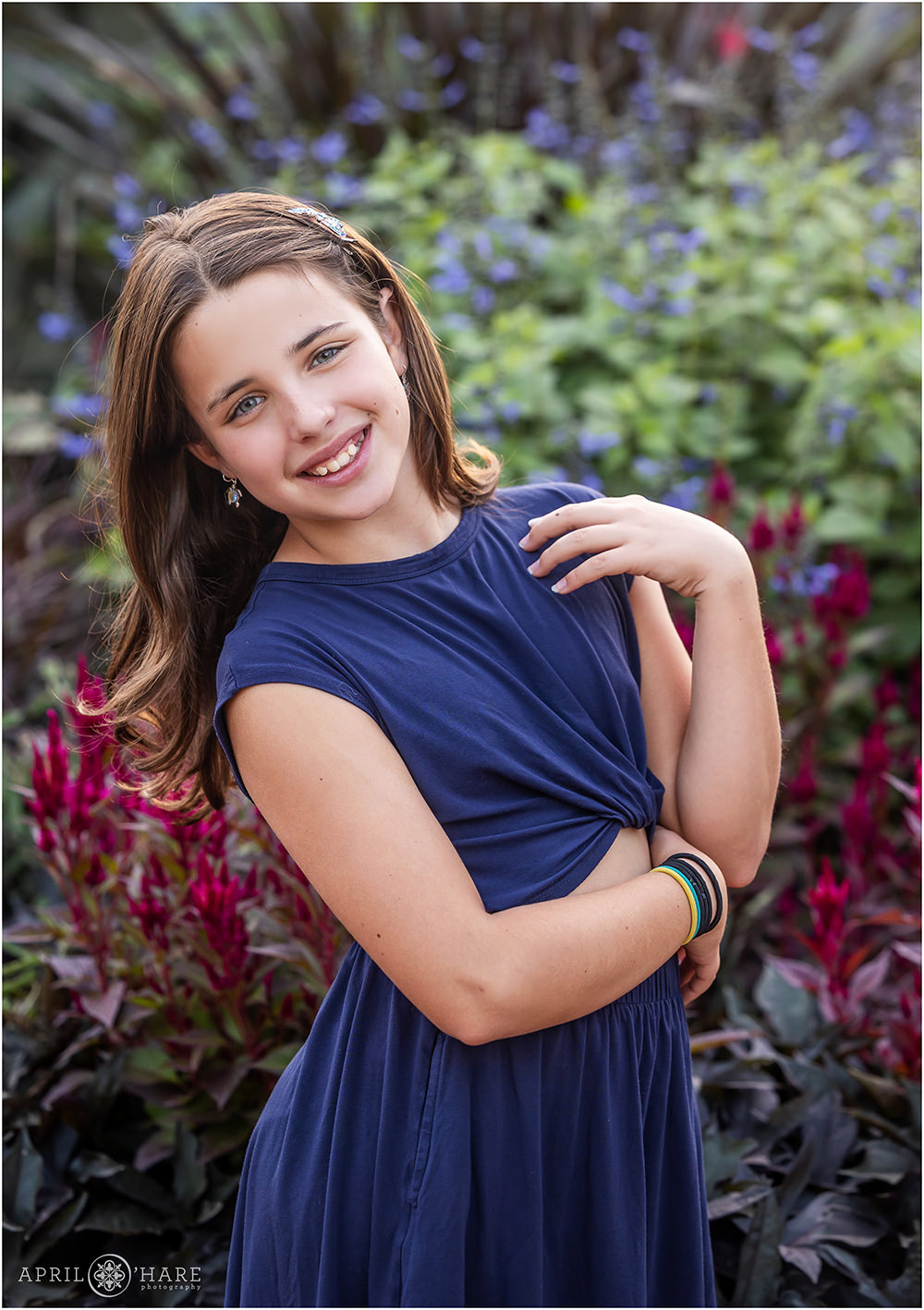 Young girl wearing navy blue with a floral backdrop at Denver Botanic Gardens in Colorado
