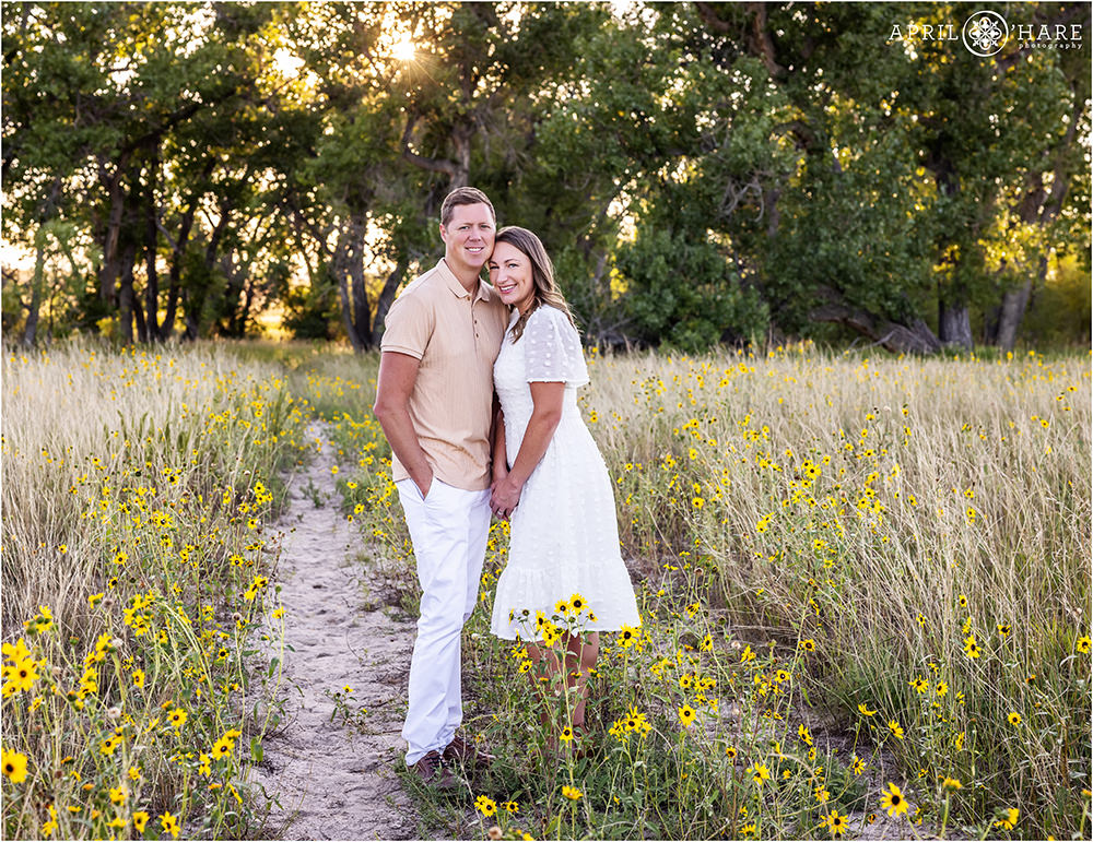 Cute couples photo in a pretty sunflower field at a family session in Parker Colorado