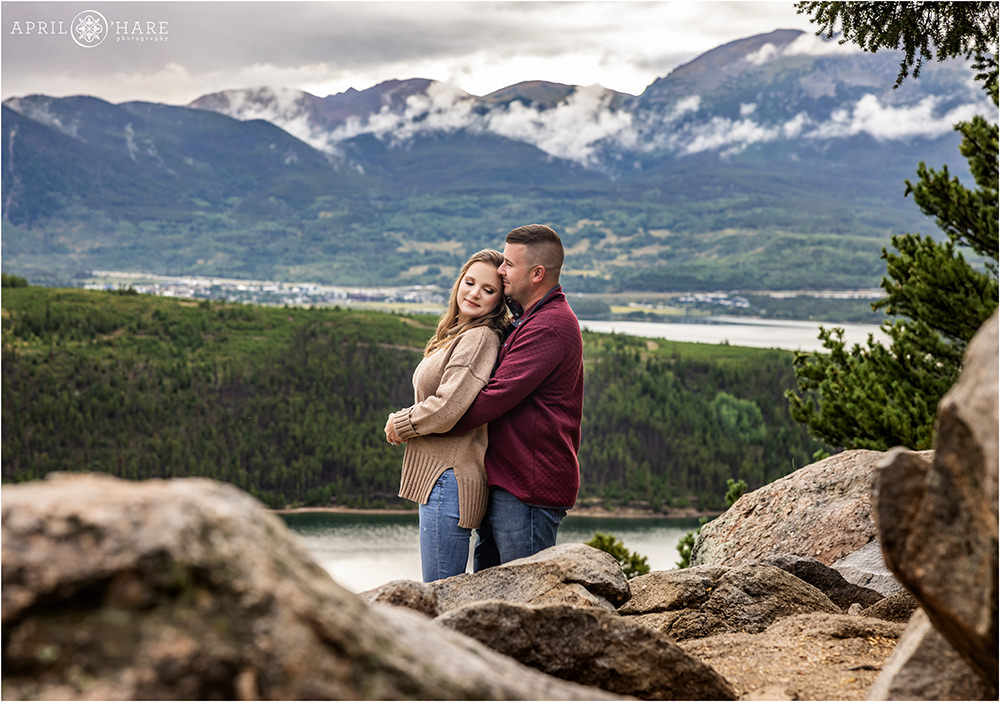 Sweet engagement photo at Sapphire Point with a misty mountain backdrop in Colorado