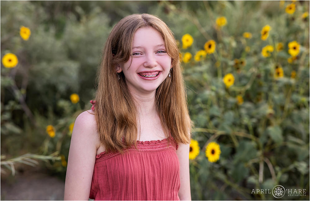Teenage girl poses in front of the wild sunflowers at James Bible Park