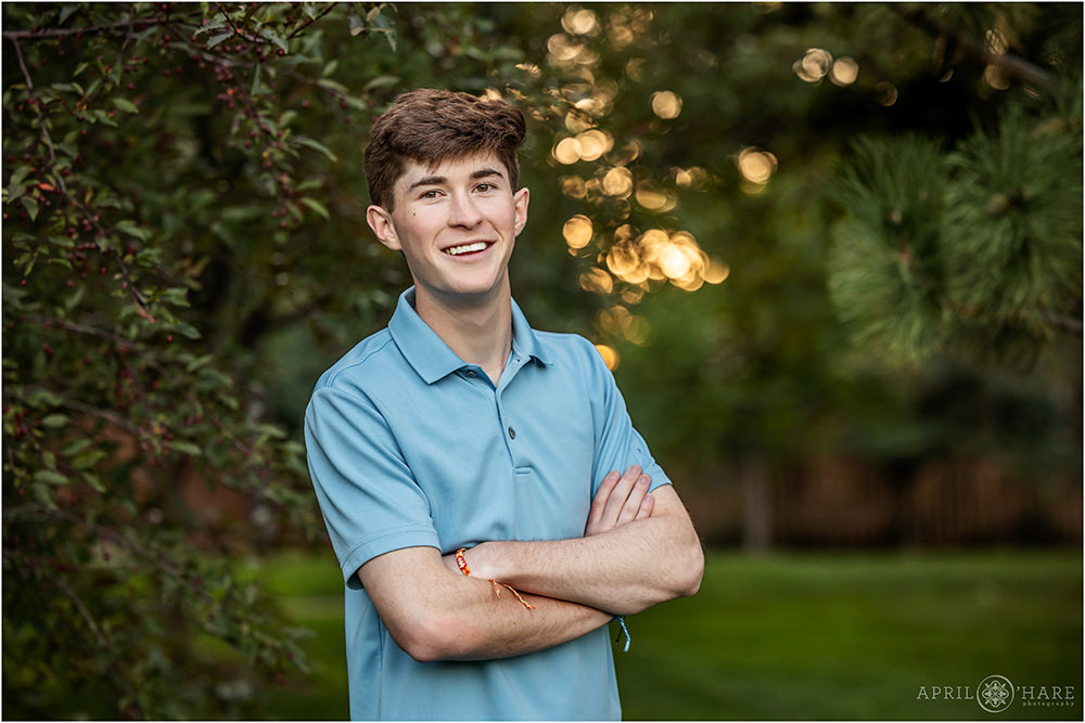 Beautiful greenery backdrop with dappled sunset light for a high school senior portrait at Tommy Davis Park in Greenwood Village CO