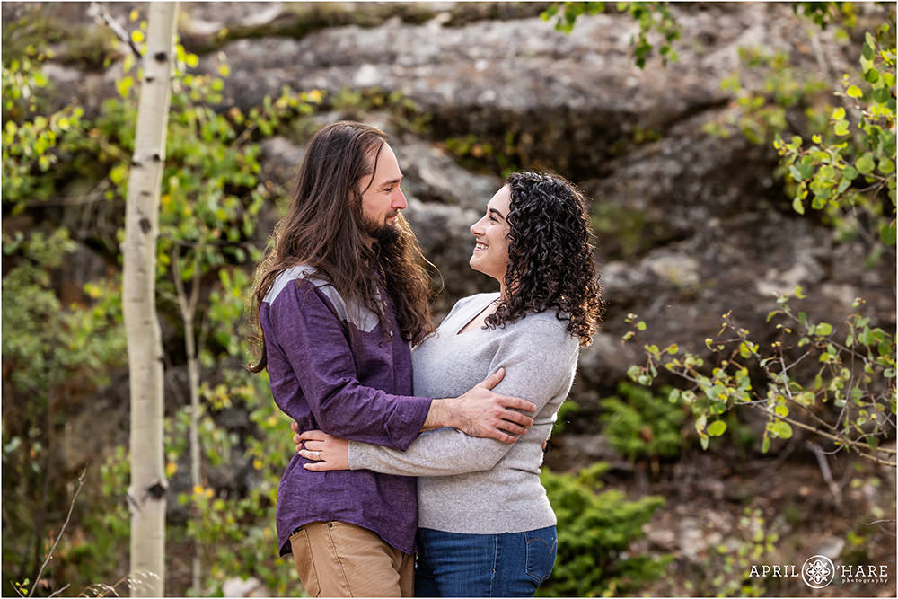 Pretty rock backdrop engagement photo at the beginning of the fall color season in Twin Lakes Colorado