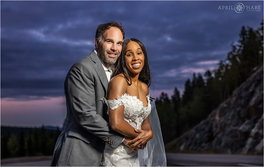 Pretty sunset photo for a couple wearing their wedding clothes on Squaw Pass Road in Evergreen Colorado