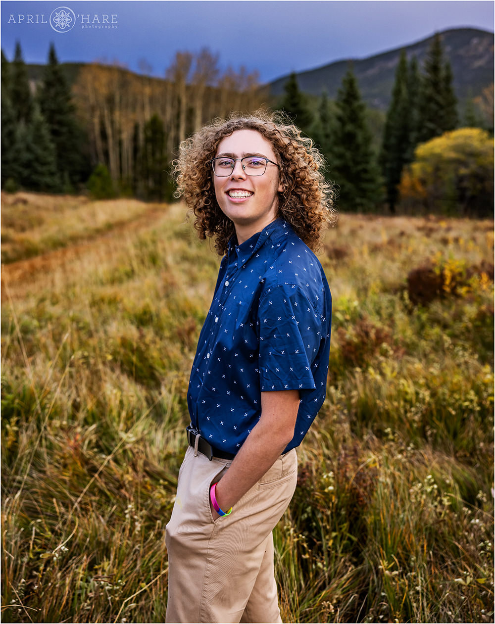 Senior portraits in a beautiful mountain meadow with fall color in Evergreen Colorado