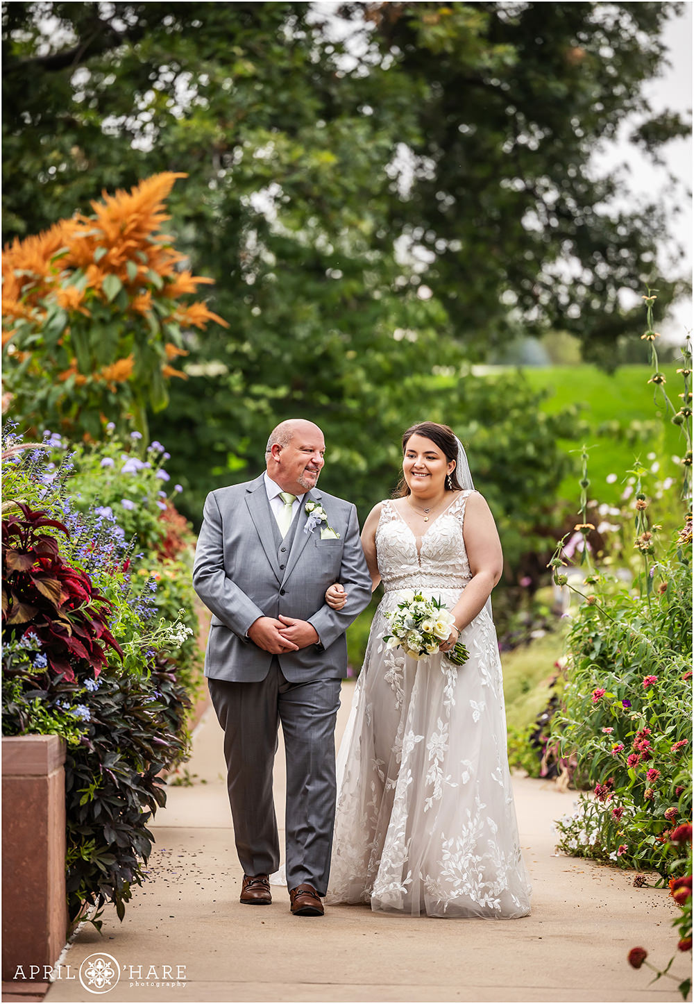 Father walks his daughter down the aisle in the Annuals Garden at Denver Botanic Gardens