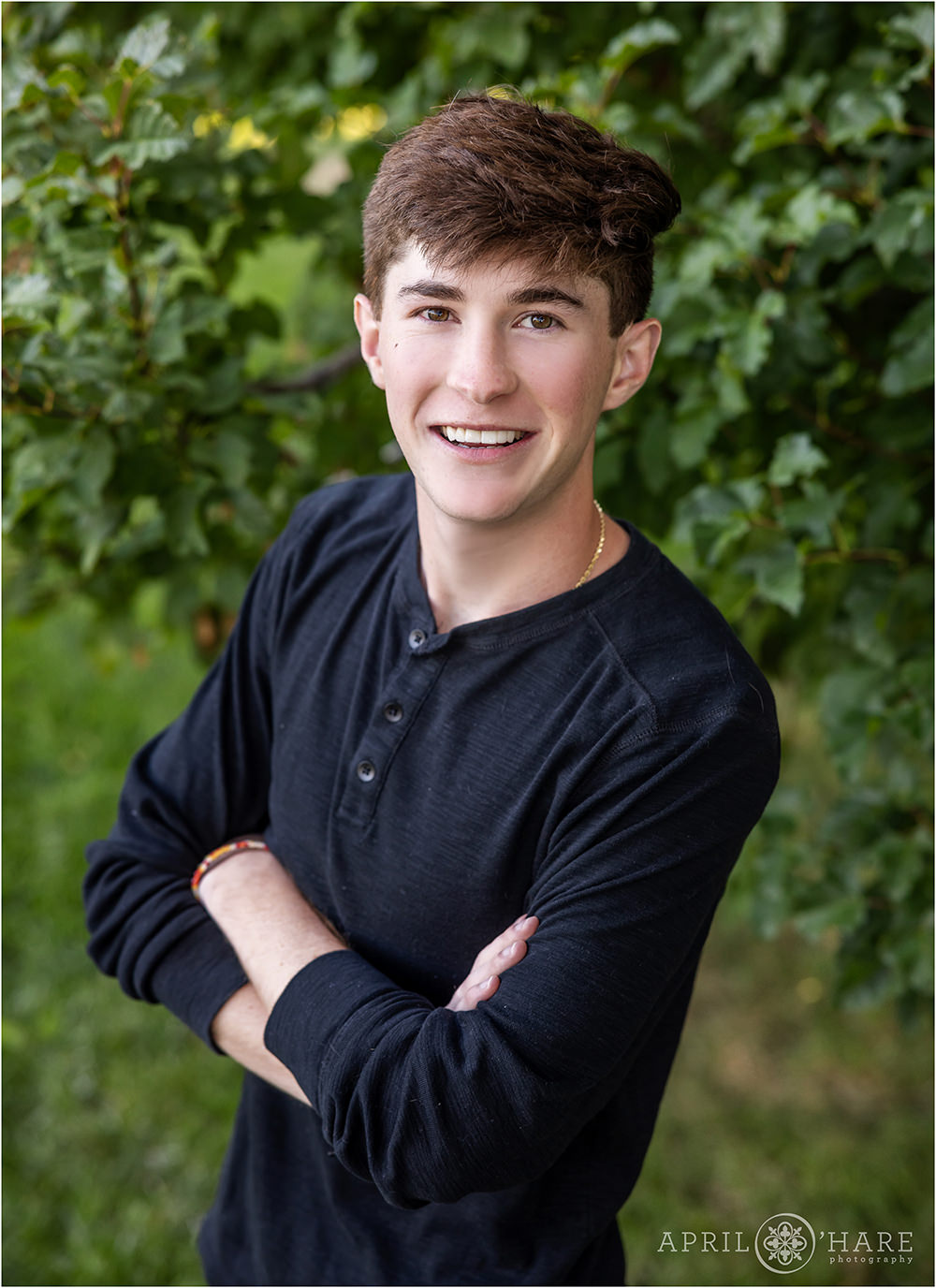 Simple greenery backdrop for a high school yearbook portrait at Tommy Davis Park in Greenwood Village, CO