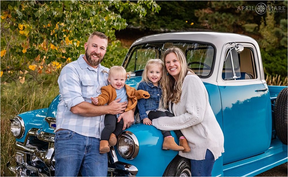 Beautiful family photo with their gorgeous blue 1950s vintage truck in Littelton Colorado