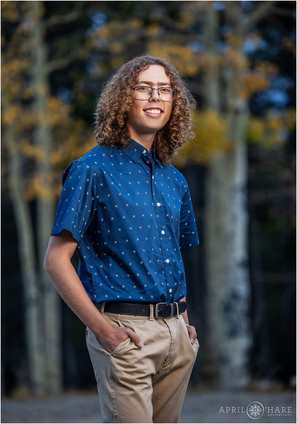 Senior portrait with fall color aspen trees backdrop in Evergreen, CO