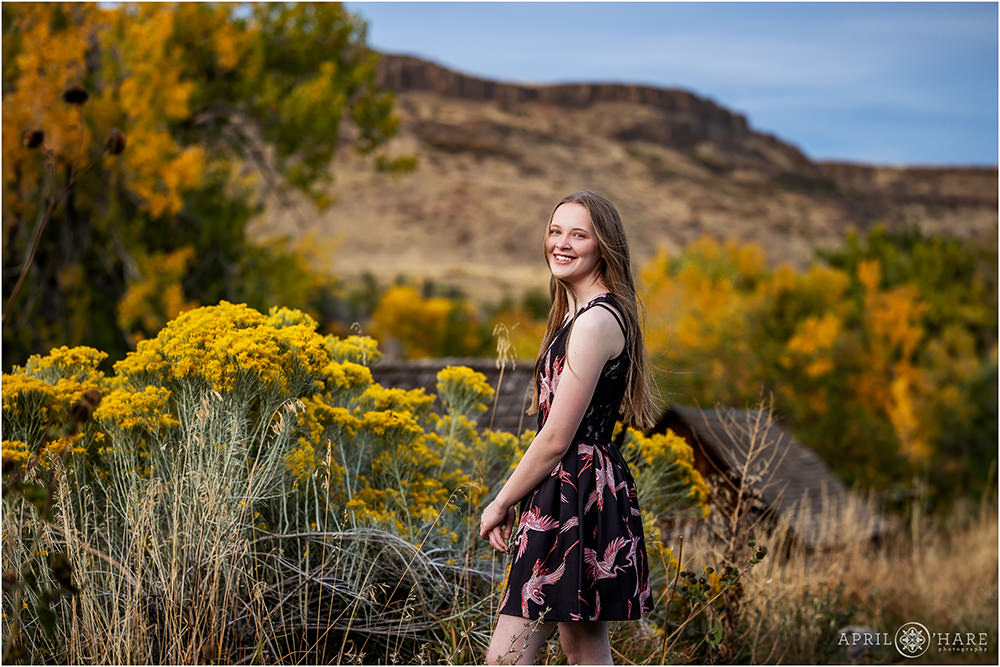 North Table Mesa fall color backdrop for a senior photoshoot at Clear Creek History Park during autumn in Golden, Colorado