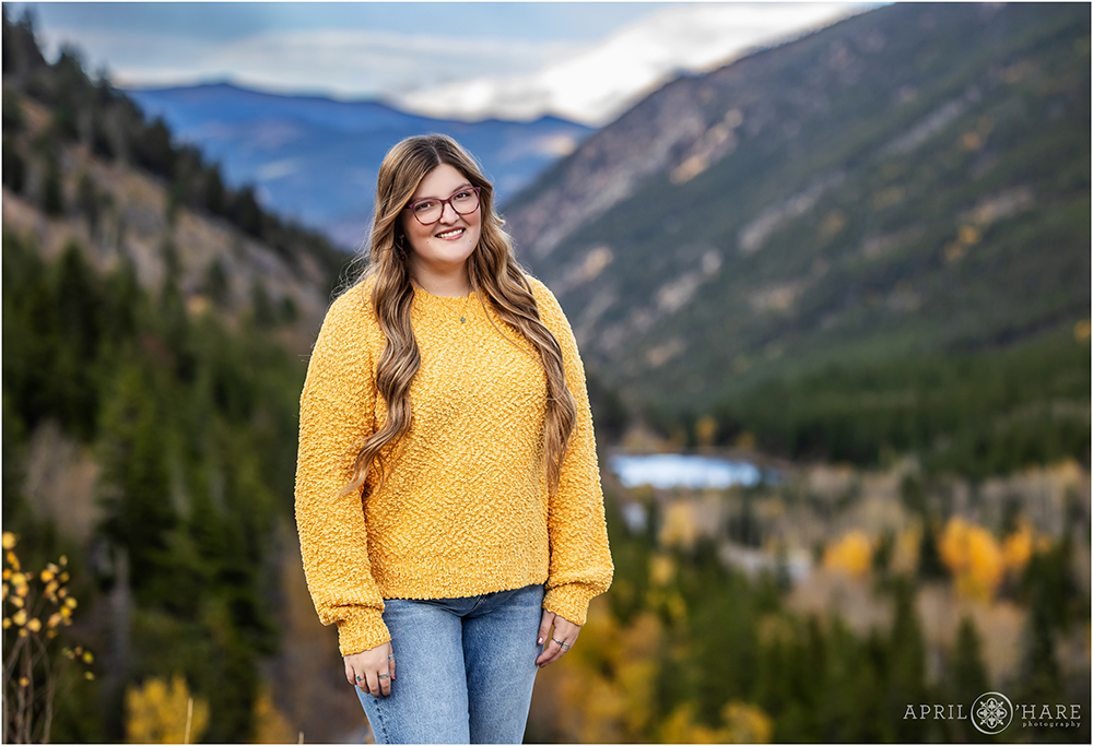 Pretty blue mountain backdrop with fall color for a high school senior photo on Guanella Pass in Colorado