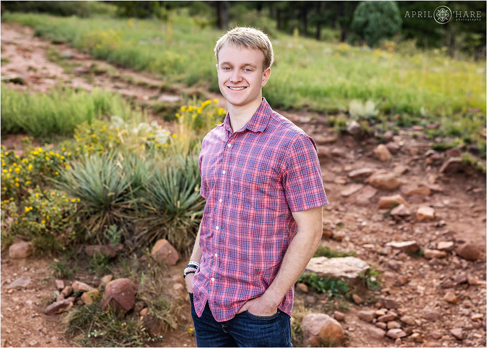Colorful plants in the backdrop for a senior portrait at Shanahan Ridge Trail in South Boulder