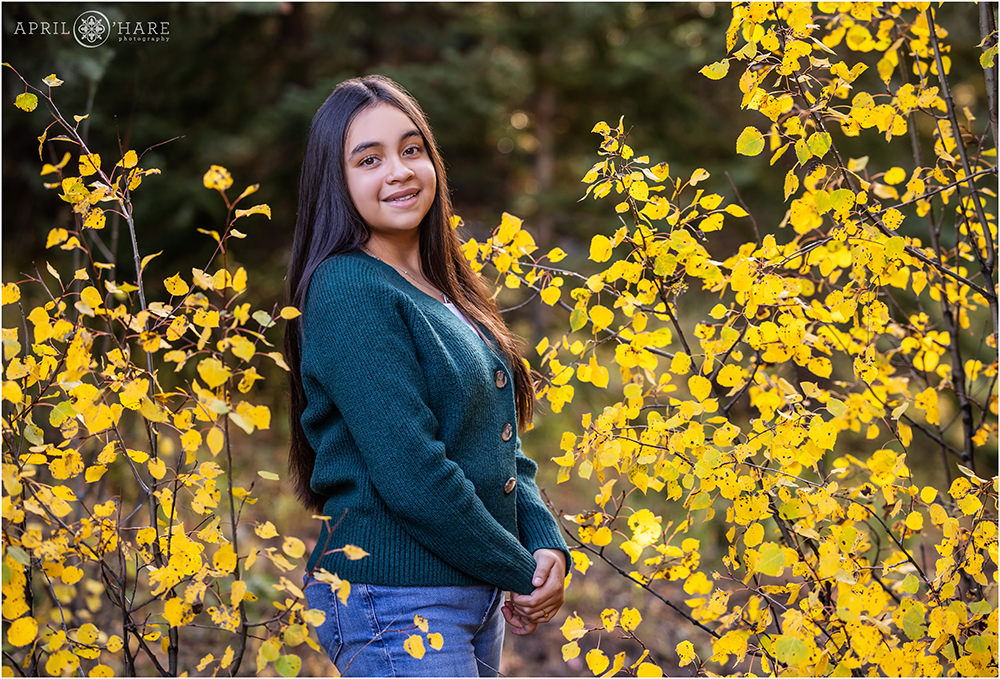 Beautiful fall color photo for a teenage girl wearing a green cardigan in Evergreen CO
