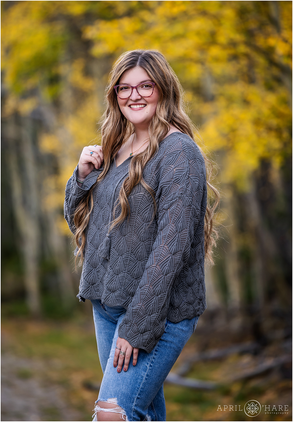 Stunning senior girl standing in front of the fall color on Guanella Pass in Colorado