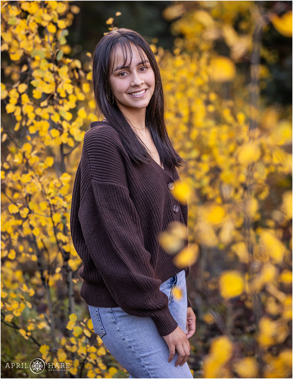 Fall Color portrait for a young woman in the aspen leaves of Evergreen CO