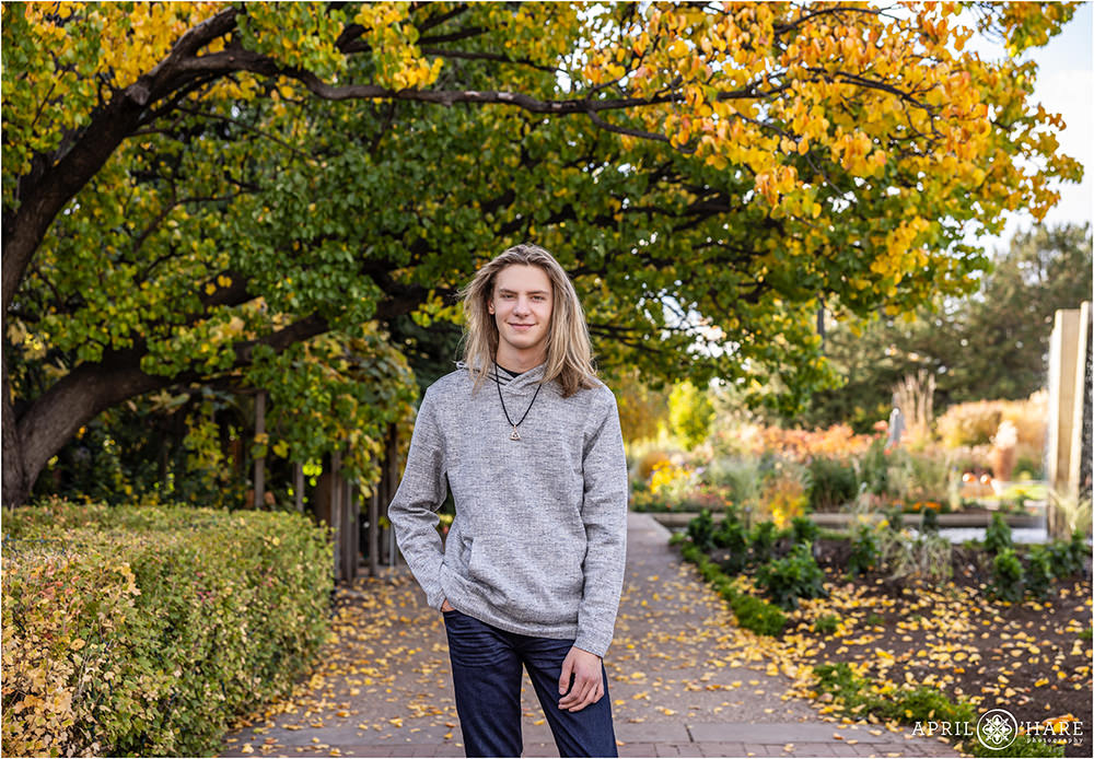 Fall color backdrop for a senior photo at Denver Botanic Gardens in Colorado