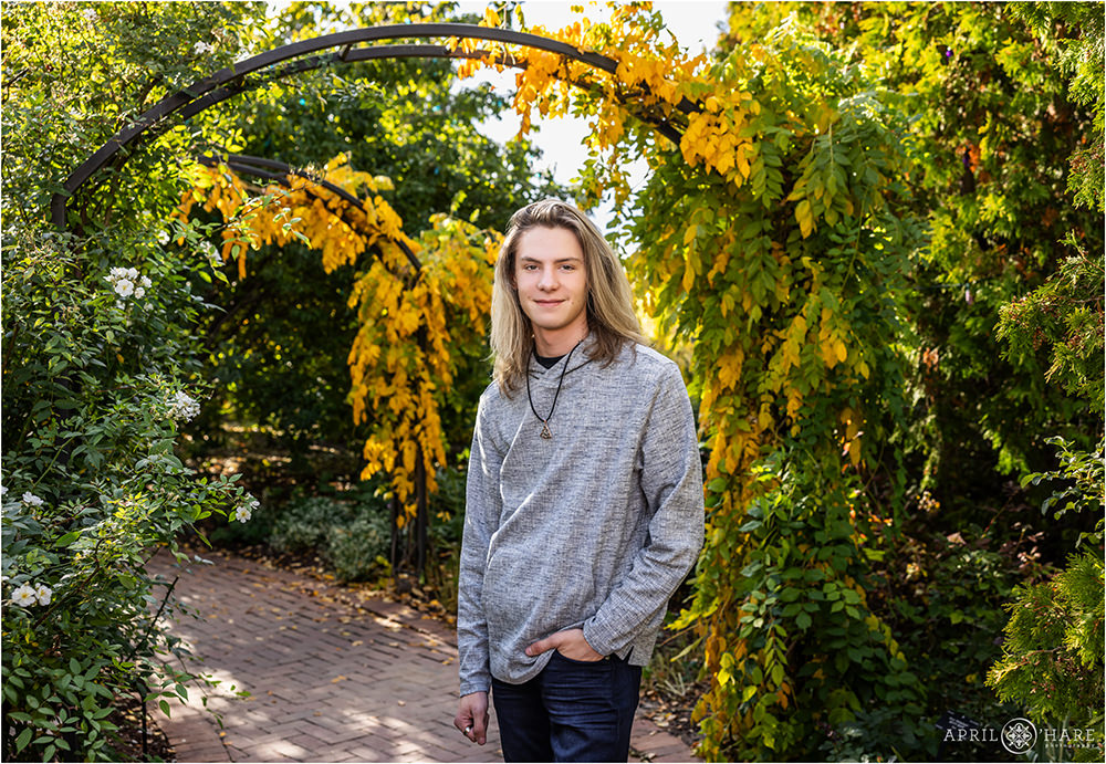 Archways covered in fall color plants for a senior photo at Denver Botanic Gardens