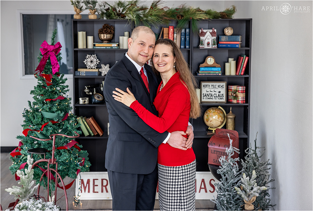 Couples portrait with a Christmas library set in Denver Colorado