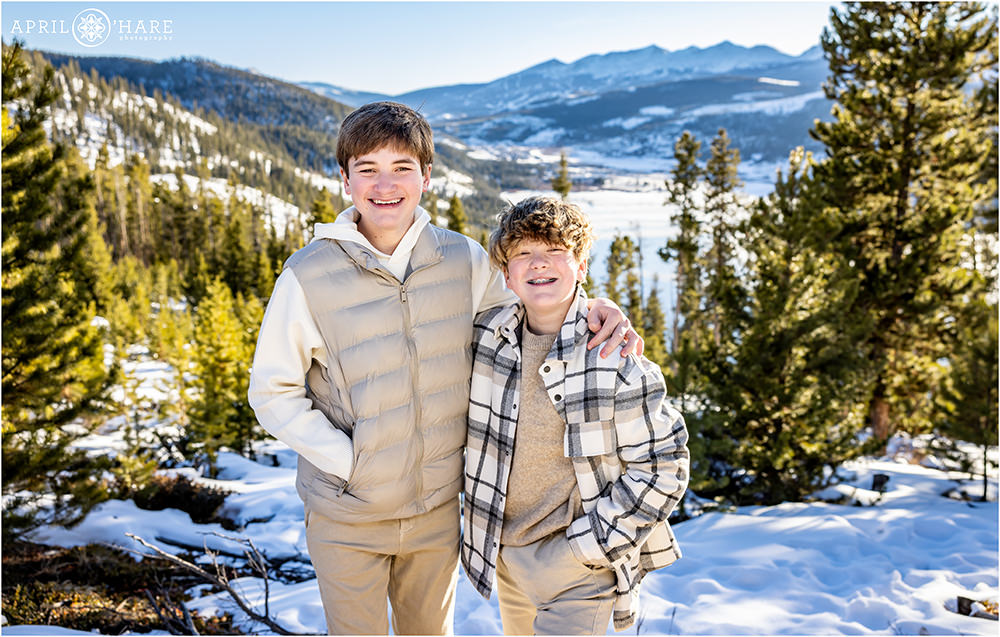 Two Brothers smile for a photo together on their family ski trip to Colorado