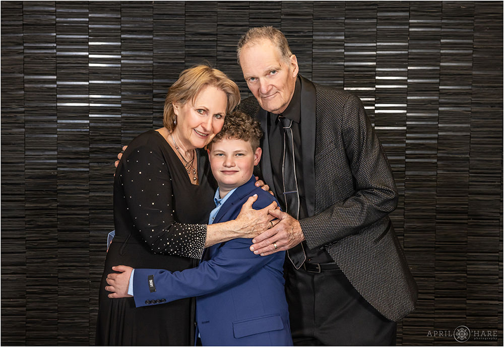 Boy with his grandparents at his bar mitzvah party in Denver