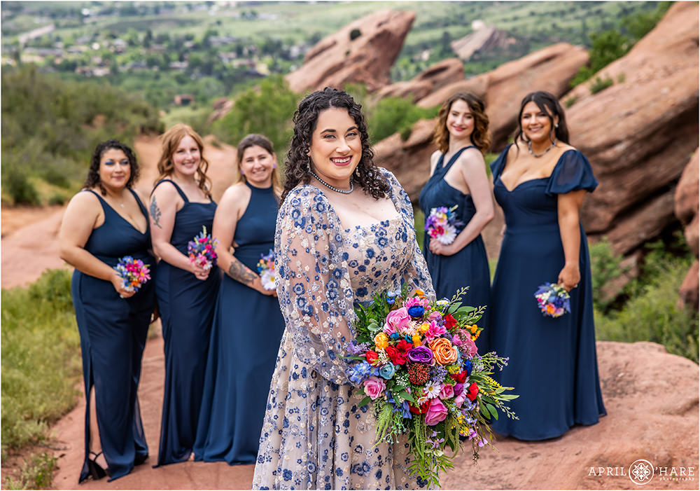 Bride with her bridal party friends with pretty red rock formations in the backdrop in Colorado