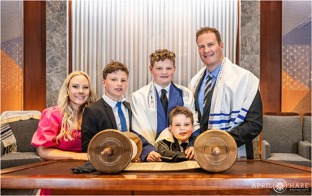 Family of 5 pose for a photo with the Torah at Temple Sinai in Denver CO
