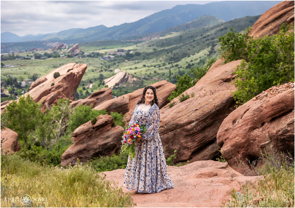 Stunning bridal portrait of a bride in a pretty, non traditional blue and white floral gown at Red Rocks on her Spring wedding day in Colorado