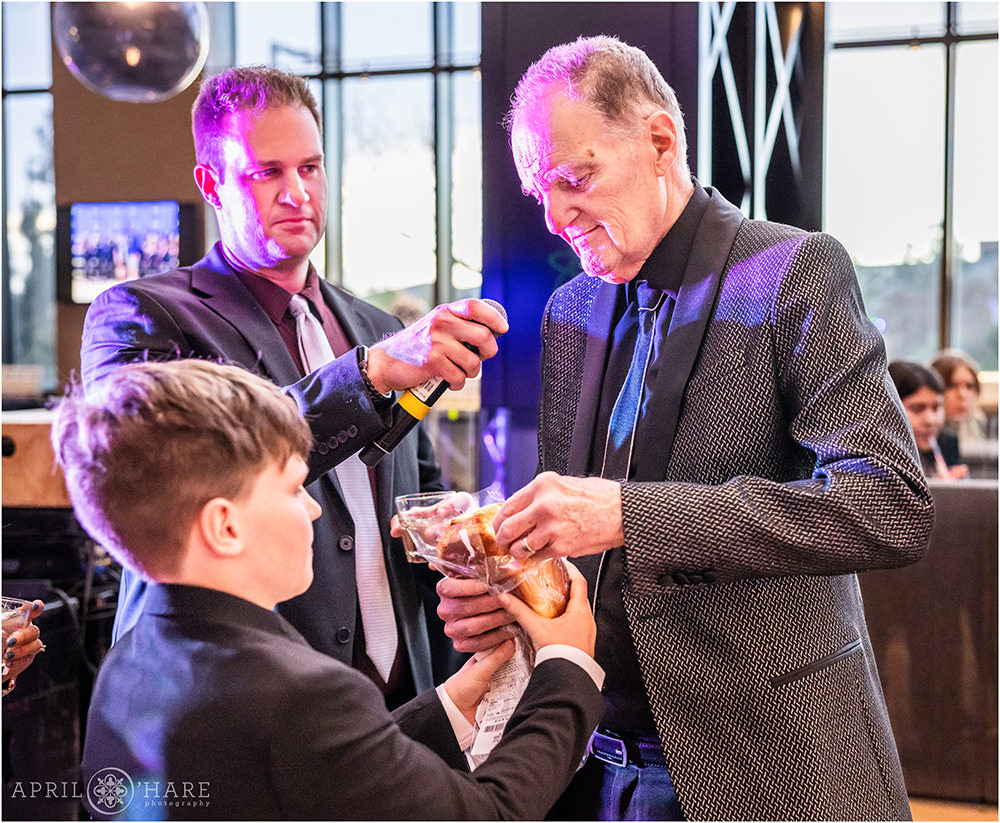 Grandfather says a Jewish prayet at his son's bar mitzvah in Denver CO