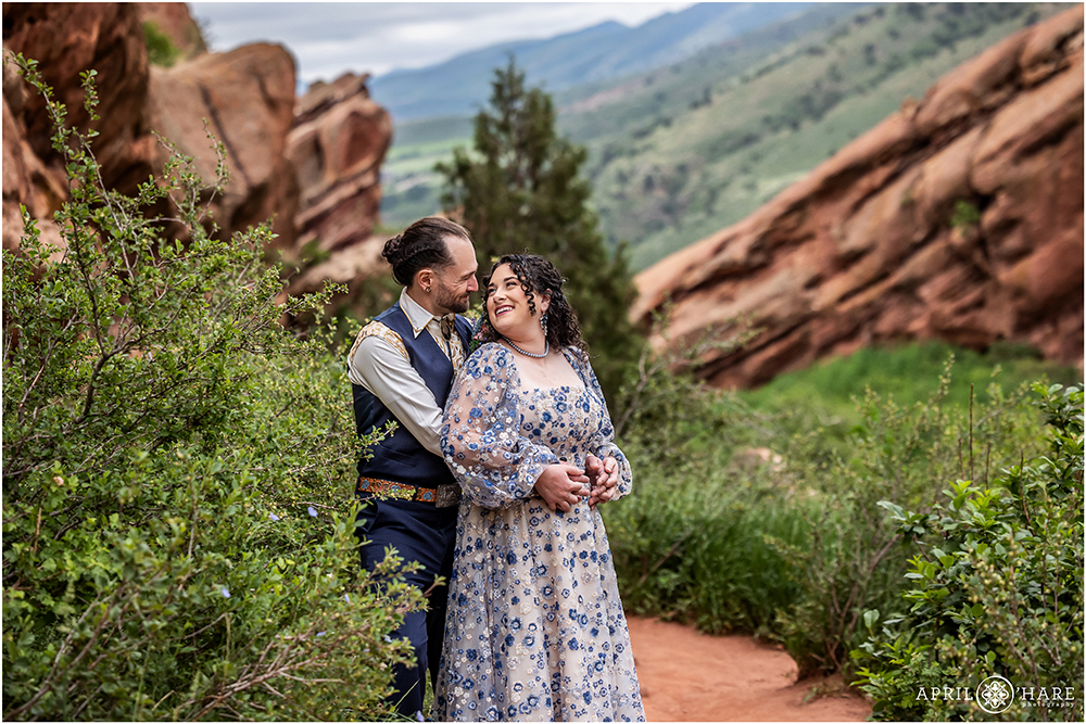 Couple in the beautiful scenery at Red Rocks on their wedding day in Colorado