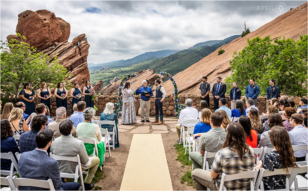 Couple surrounded by friends and family as they get married at the Red Rocks Trading Post in Colorado