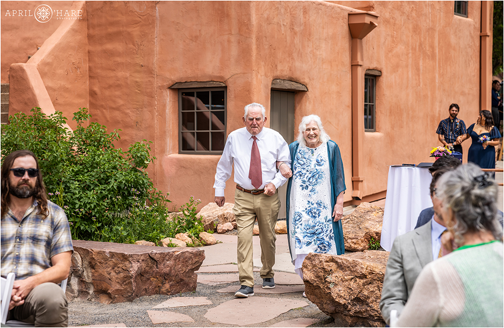 Family walk down the aisle at Red Rocks Trading Post Backyard Wedding
