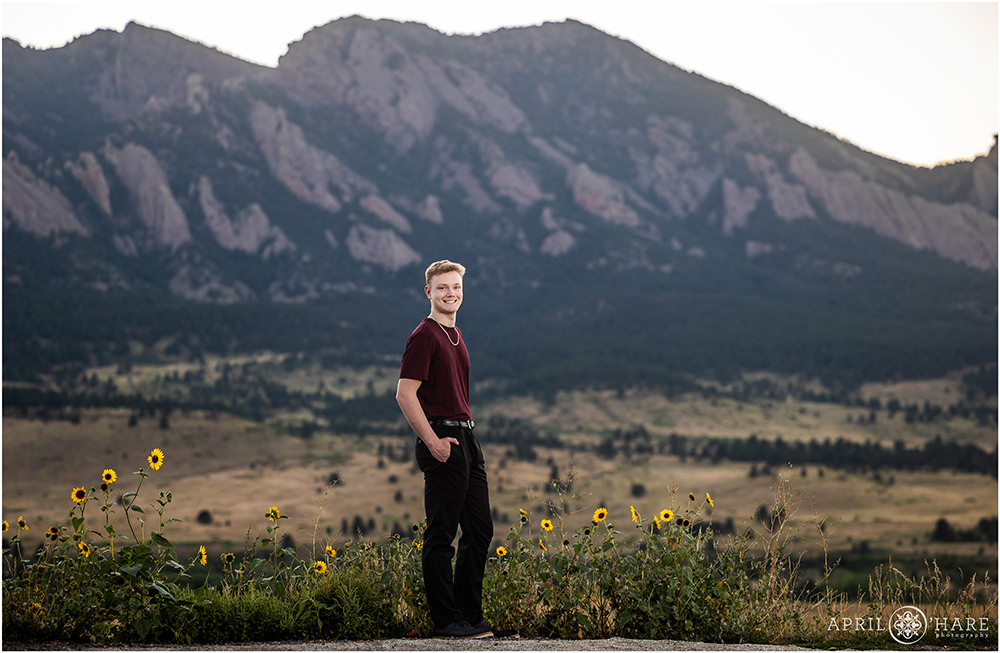 Beautiful mountain backdrop with sunflowers for senior photos in Boulder Colorado