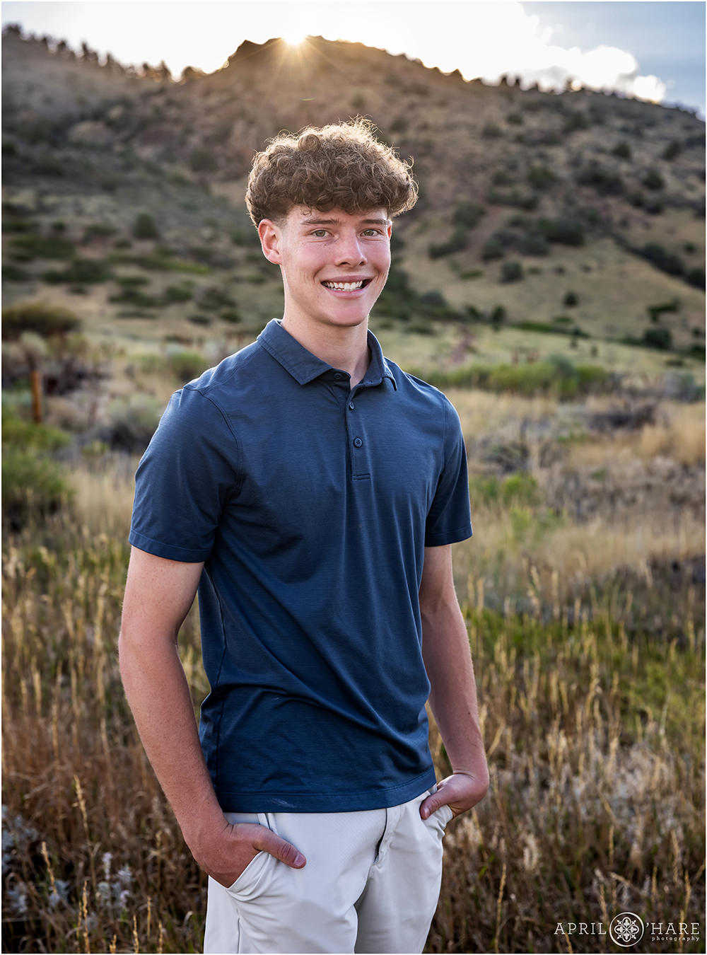 High school senior boy wearing a navy blue collared shirt at Morrison Trailhead in Colorado