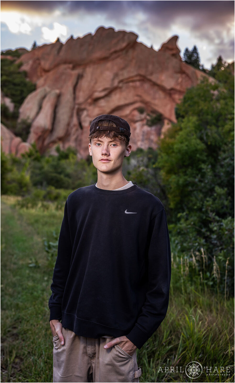 Senior Photo with dramatic sunset sky at Roxborough State Park in Colorado