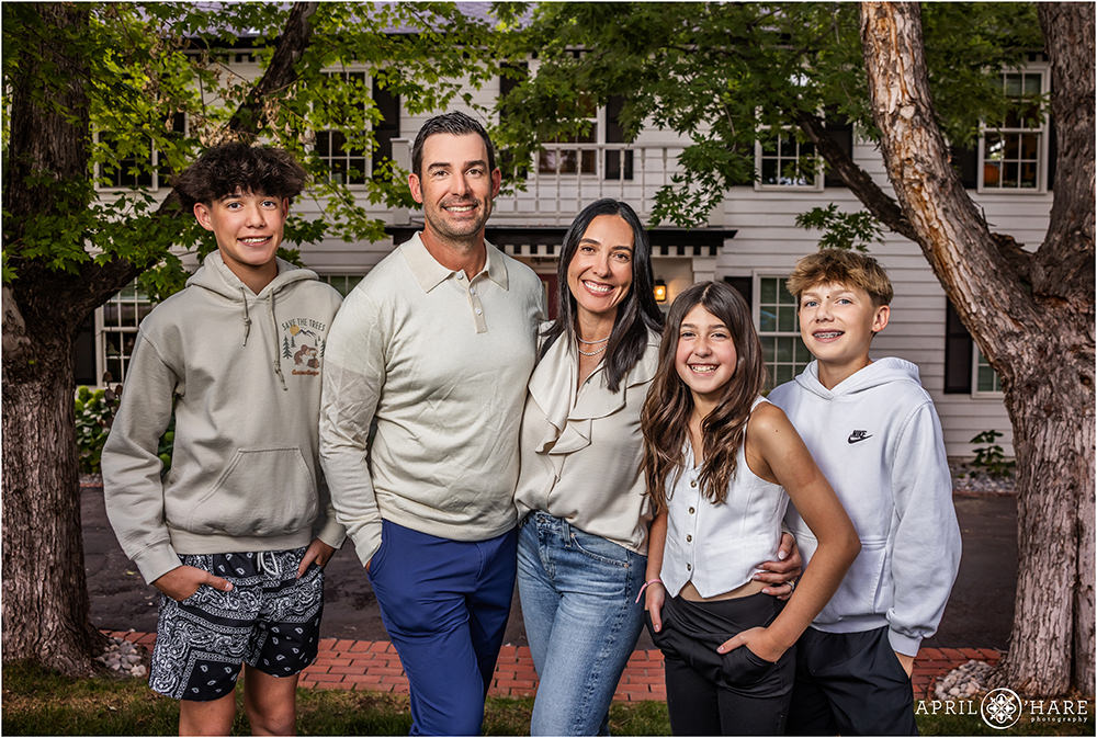 Family of Five pose in the yard in front of their house in Colorado