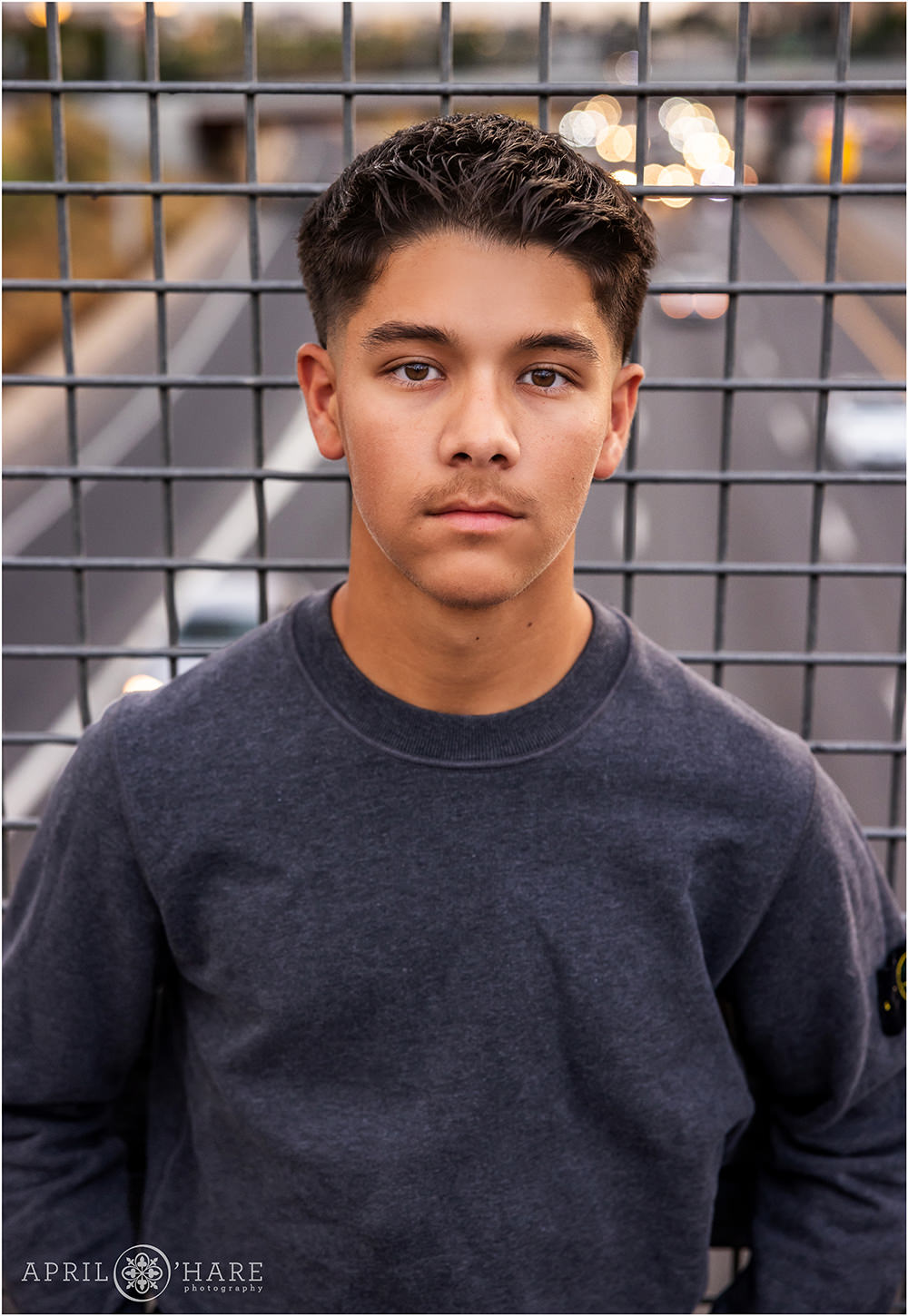 Senior photo on a bridge over I-25 in downtown Denver Colorado