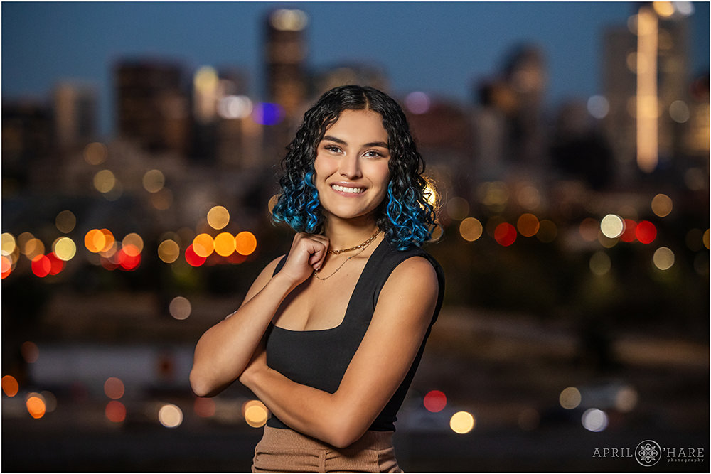 Beautiful glowing city lights backdrop for high school senior yearbook session in Denver Colorado