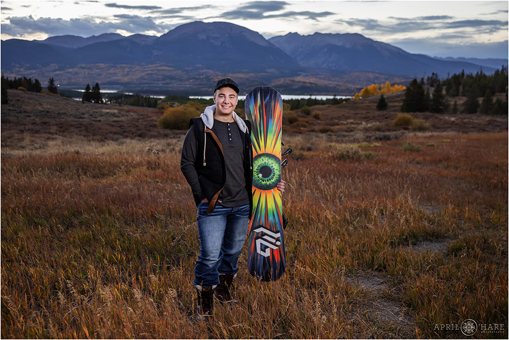 Snowboarder Senior Photo with Snowboard during fall in Summit County Colorado