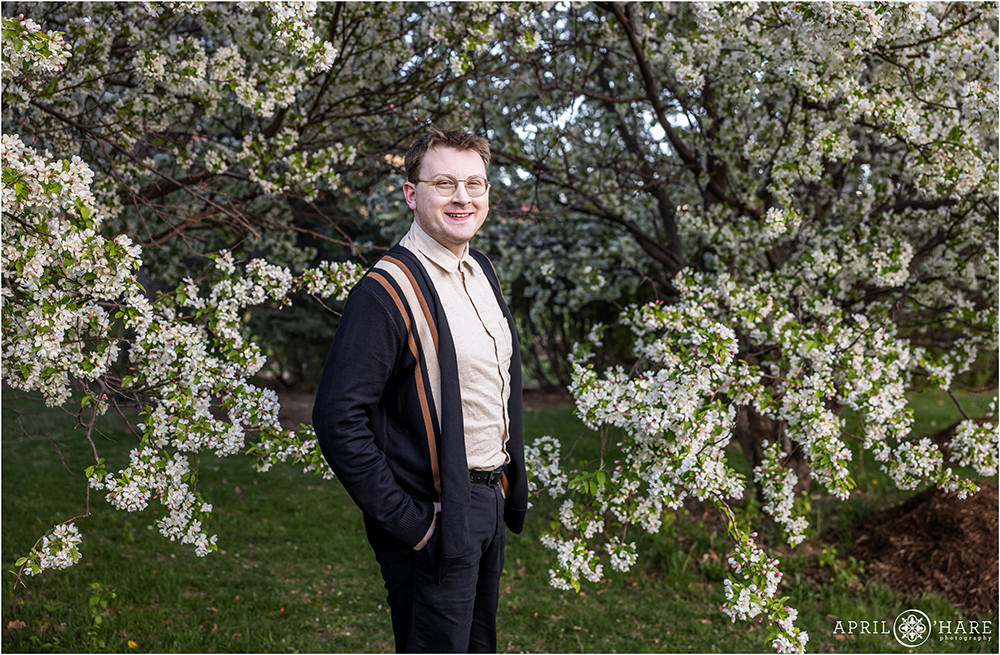 Spring time blossom backdrop for a college graduate updating his headshots at City Park in Denver CO
