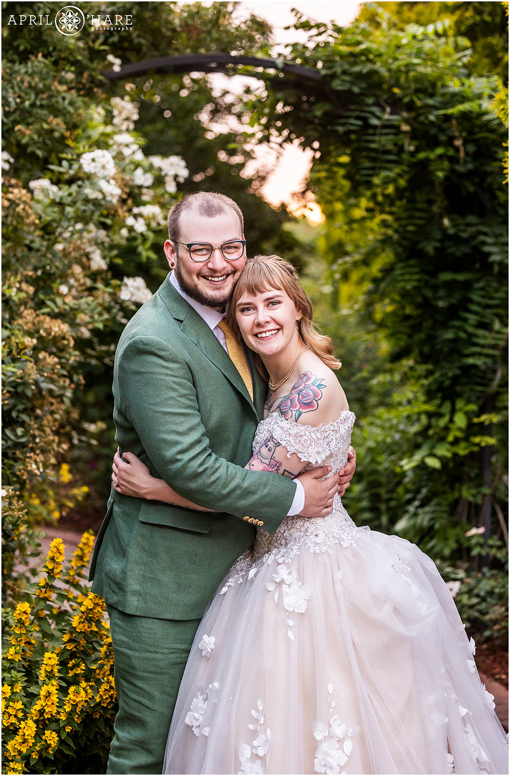 Classic wedding portrait of a couple on their wedding day on a pretty path at Denver Botanic Gardens around sunset