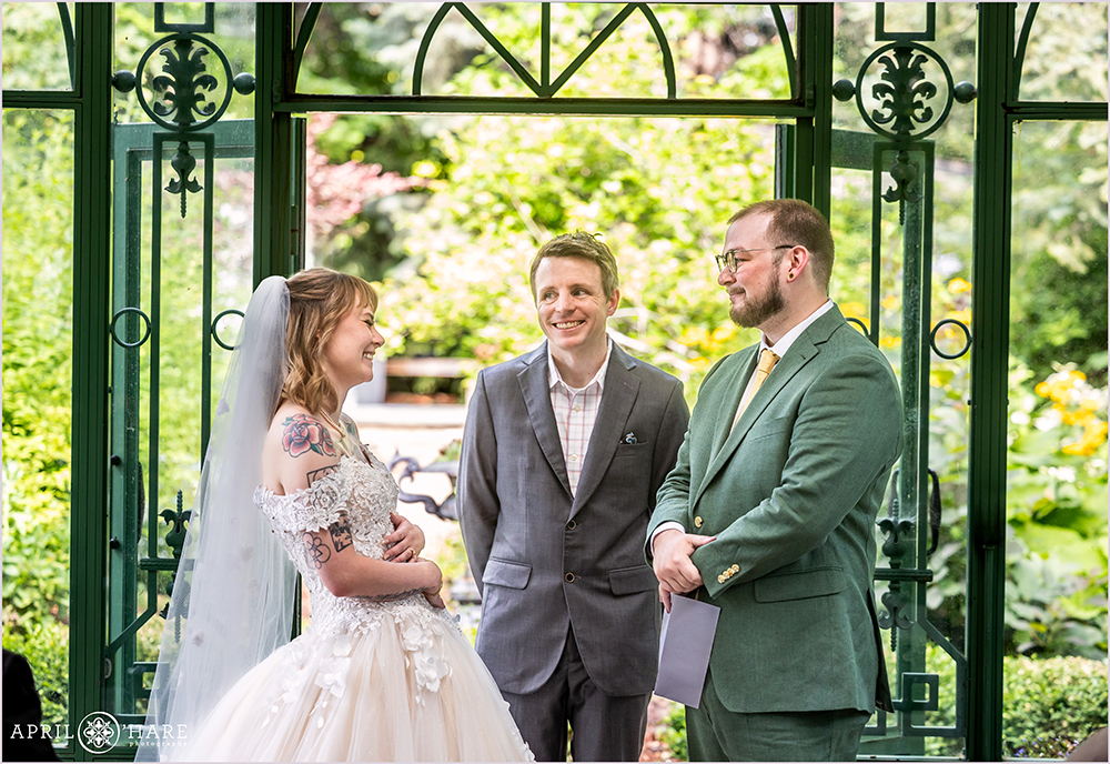 Couple laugh on their wedding day at Woodland Mosaic Solarium at Denver Botanic Gardens