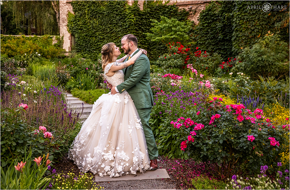 Gorgeous colorful garden setting for a romantic wedding photo at sunset in the Oval garden at Denver Botanic Gardens