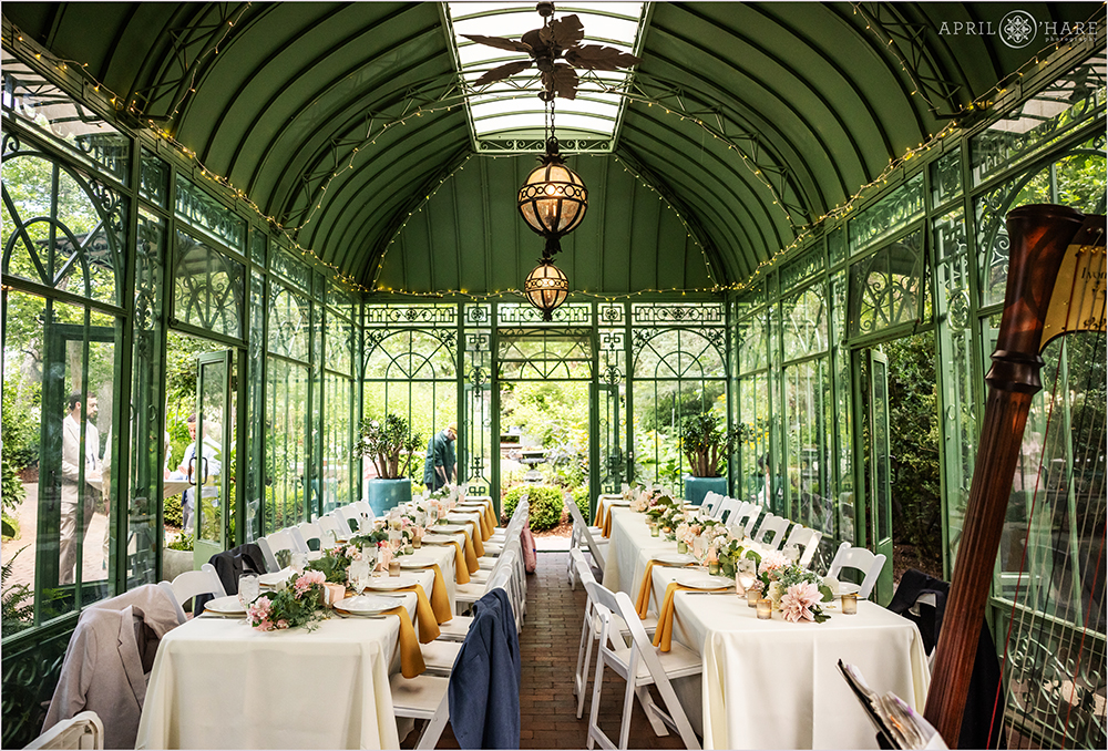 Pretty summer wedding reception dinner inside the Woodland Mosaic Greenhouse at Denver Botanic Gardens