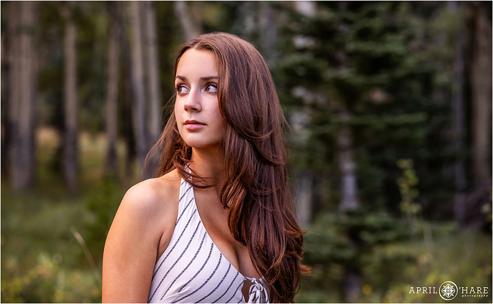 Quiet contemplative senior photo in the woods of Colorado