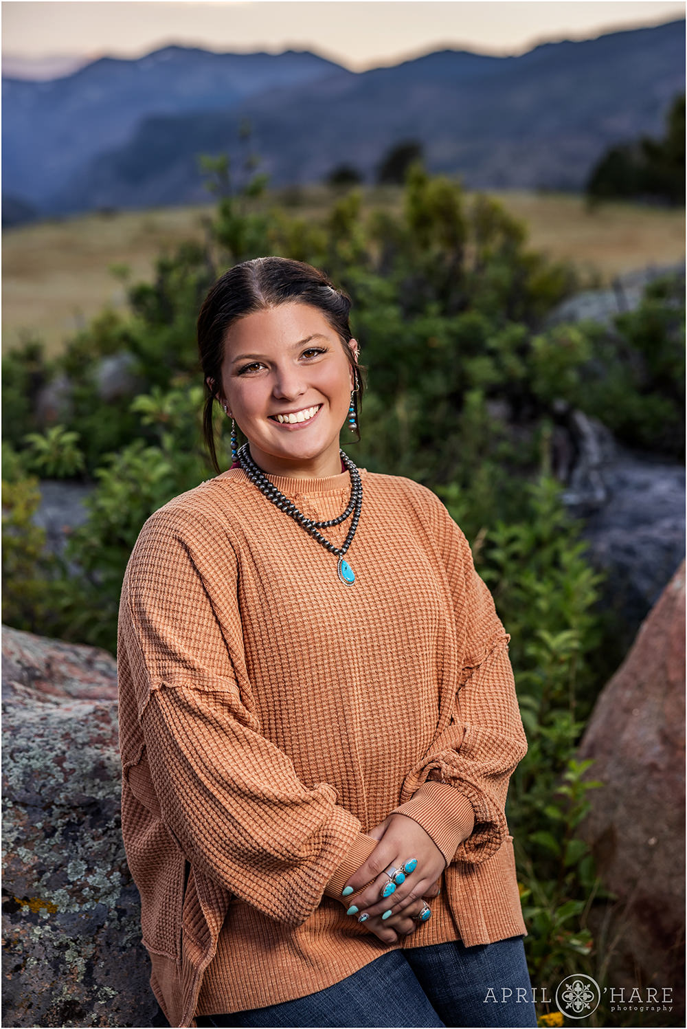 Beautiful senior portrait with mountain backdrop at Rocky Mountain National Park in Estes Park CO