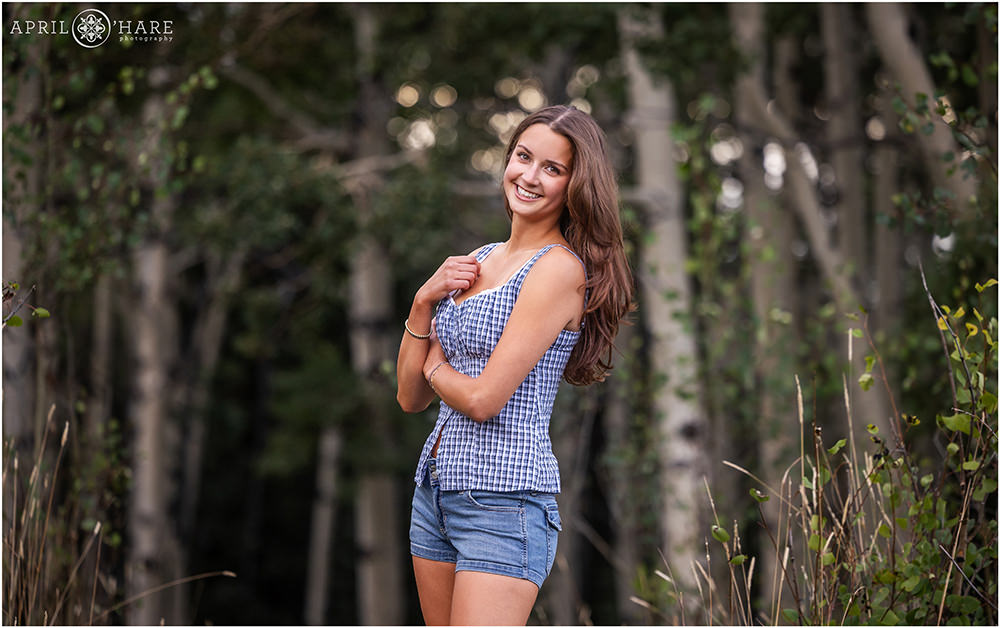 Pretty senior photo in an aspen tree forest in the mountains of Colorado